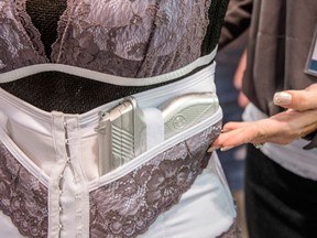 In this April 29, 2016, photo, Anna Taylor, founder and CEO of Dene Adams LLC, poses in Atlanta, Ga, showing one of the corsets her company designs. For decades, women have had few choices when it comes to the clothing they can wear to hide that they’re carrying a firearm. Taylor's company makes clothing geared to women seeking to carry a firearm concealed. (AP Photo/Lisa Marie Pane)