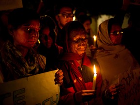 In this Dec. 16, 2014 file photo, acid attack survivors participate in a candlelit vigil protesting violence against women as they mark the second anniversary of the deadly gang rape of a student on a bus, in New Delhi, India. An Indian court has on Thursday, Sept. 8, 2016, sentenced a man to death for killing his 23-year-old woman neighbour by throwing sulfuric acid at her for refusing to marry him three years ago. This is the first death punishment for an acid attack under stringent laws framed by the government to curb crimes against women following a fatal gang rape of a young woman in a moving bus in New Delhi in 2012. (AP Photo/Saurabh Das, File)