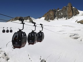 This file photo taken on August 5, 2015 shows the Panoramic Mont-Blanc cable car linking the Aiguille du Midi peak to the Helbronner peak in Italy, above the seracs and crevasses of the Glacier des Géants (Glacier of the Giants). About 110 people were stranded on September 8, 2016 in gondolas above the glaciers of Mont Blanc and had to be rescued by helicopter down into the valley. / AFP PHOTO / PHILIPPE DESMAZESPHILIPPE DESMAZES/AFP/Getty Images