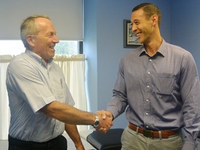 Dr. Peter Wakely, left, shakes hands with Dr. Matthew Clifford. Clifford is taking over Wakely's practice in Corunna. (Submitted)