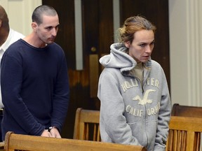 Ryan J. Barry, left, and Ashley Cyr, right, are led into Brockton, Mass., Superior Court for arraignment Friday, Oct. 11, 2013, on charges of manslaughter in the death of their 5-month-old daughter Mya Berry, by giving her a bottle of formula with heroin in September 2011. (AP Photo/Boston Herald, Ted Fitzgerald, Pool)