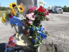 A floral memorial for St. Norbert Collegiate teacher Michael Slobodian is seen at the Perimeter Highway and St. Anne's Road on Thursday. (Brian Donogh/Winnipeg Sun)