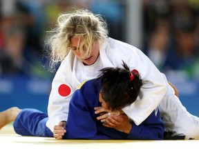 Priscilla Gagne, right, wrestles with Uzbekistan's Sevinch Salaeva during the women's judo 52-kilogram bronze-medal match at the Rio Paralympics on Thursday. Gagne, a 30-year-old former Sarnia resident, lost the match. (Leah Hennel/Postmedia)