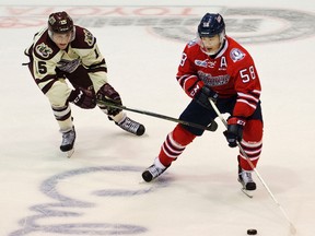Nick Isaacson of the Peterborough Petes tries to steal the puck from Oshawa Generals defenceman Mitchell Vande Sompel during OHL preseason action in Peterborough in September. (Jessica Nyznik/Postmedia Network)