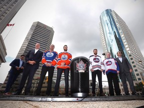Edmonton Oilers Vice Chair Oilers Entertainment Group/Alternate Governor Kevin Lowe, left to right, Edmonton Oilers alumnus Dave Semenko, Oilers goalender Cam Talbot, Winnipeg Jets forward Blake Wheeler and Jets alumni Thomas Steen and Dale Hawerchuk show off the Heritage Classic jerseys as the National Hockey League announce the rosters at a Tim Hortons NHL Heritage Classic press event at Winnipeg's Portage and Main intersection on Friday, August 5, 2016.