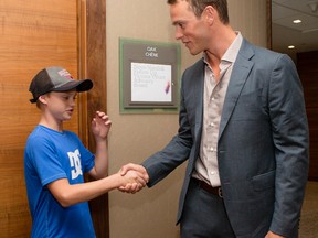 Team Canada's Jonathan Toews (right) shakes hands with Tomislav Brennan, 11, in Ottawa.