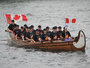 In this handout file photo from 2011, a canoe filled with current and former cadets from the Royal Military College of Canada arrives in Kingston, Ont. following a trip down the Rideau Canal to raise donations for the college athletics programs. Handout photo Postmedia Network