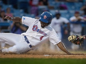 Ottawa Champions’ Albert Cartwright slides past the glove of New Jersey Jackals catcher Richard Stock during Game 2 of their playoff series at RCGT Park. (Jason Ransom, Postmedia Network)