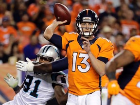 Broncos quarterback Trevor Siemian (13) throws under pressure from Panthers defensive end Ryan Delaire (91) during second half NFL action in Denver on Thursday, Sept. 8, 2016. (Jack Dempsey/AP Photo)