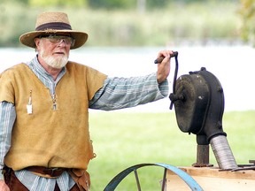 Richard Mackey, from Allenford, Ont., cranks a fan as part of his job as a blacksmith's apprentice, at the Selkirk History Faire at MacDonald Park near Port Lambton on Saturday, August 27, 2016. The Selkirk History Faire is a re-enactment/rendezvous that depicts life in the frontier encampment from 1775 to 1840. David Gough/Postmedia Network