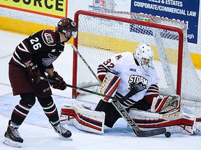 Belleville native Anthony Popovich, a rookie OHL goalie with the Guelph Storm, makes one of his 27 saves in a 4-0 shutout win at Peterborough in pre-season exhibition play Thursday night. (Peterborough Examiner photo)