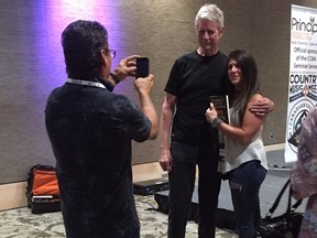 Ralph Murphy poses for a photo Friday with a fan after a songwriting workshop as part of Country Music Week in London. (Patrick Maloney, The London Free Press)