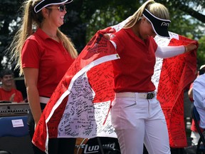 Golfer Brooke Henderson and sister/caddie Brittany Henderson are celebrated during a community event in their honour in their hometown of Smiths Falls, Ont., on Friday, Sept. 9, 2016. (THE CANADIAN PRESS/Sean Kilpatrick)