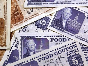 Older, traditional food stamps are displayed June 24, 2004 at an Illinois Department of Human Services office in Skokie, Illinois. Agriculture Secretary Ann M. Veneman has announced all 50 states and the U.S. territories now provide Food Stamp Program benefits with EBT (Electronic Benefits Transfer) cards instead of the traditional paper coupon stamps. (Photo by Tim Boyle/Getty Images)