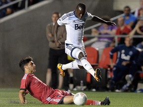 Ottawa Fury FC’s Mauro Eustaquio, bottom, kicks the ball away from Vancouver Whitecaps’ Kekuta Manneh in Ottawa on Wednesday, June 1, 2016. (THE CANADIAN PRESS/Sean Kilpatrick)