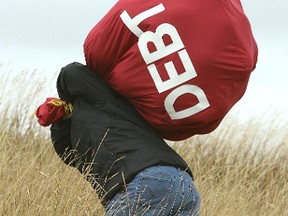 Man carries a debt bag.
Postmedia Network