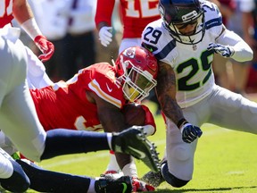 Kansas City Chiefs running back Spencer Ware (32) is tackled by Seattle Seahawks safety Earl Thomas (29) during the first half of an NFL preseason football game in Kansas City, Mo. (AP Photo/Nati Harnik, File)