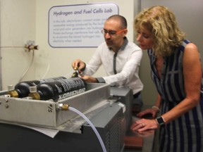 Lambton College's Shahram Karimi and Judith Morris pose with a hydrogen flow meter at the college's Sustainable Smart House Friday. The college recently received $2.3 million in federal funding for applied research. (Tyler Kula/Sarnia Observer)