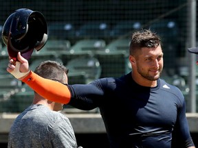 In this Aug. 30, 2016, file photo, former NFL quarterback Tim Tebow finishes his work out for baseball scouts and the media in Los Angeles. (AP Photo/Chris Carlson, File)