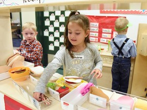 Kindergartner Aubree Lucas makes a sandwich with Colby Rafuse while Darius Ilascu (back) organizes supplies in their restaurant during their first day of school at newly opened Isabel Campbell Public School on Wednesday September 7, 2016 in Grande Prairie, Alta. (Svjetlana Mlinarevic/Daily Herald-Tribune/Postmedia Network)