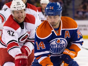 The Edmonton Oilers' Jordan Eberle (14) battles the Carolina Hurricanes Kris Versteeg (32) during first period NHL action at Rexall Place, in Edmonton Alta. on Monday Jan. 4, 2016.