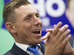 Ontario PC Leader Patrick Brown applauds as he stands on the podium during a victory party for newly elected Scarborough-Rouge River MPP Raymond Cho on Sept.1, 2016. (THE CANADIAN PRESS)