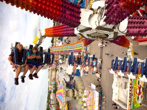 The Fireball offers these Western Fair-goers a wild new perspective on the fall classic?s opening day Friday. (MIKE HENSEN, The London Free Press)