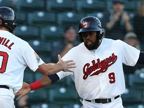 Winnipeg Goldeyes second baseman Casio Grider (right) is congratulated by Wes Darvill after scoring against the St. Paul Saints during Game 2 of the American Association semifinal at Shaw Park in Winnipeg on Fri., Sept. 9, 2016. (Kevin King/Winnipeg Sun/Postmedia Network)
