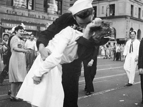 In this photograph released by the United States Navy, a sailor and nurse embrace in New York's Times Square in a file photo from Aug. 14, 1945. The woman kissed by an ecstatic sailor in Times Square celebrating the end of World War II, in a photo made famous by Life photographer Alfred Eisenstaedt, has died. (AP Photo/United States Navy, Victor Jorgensen)