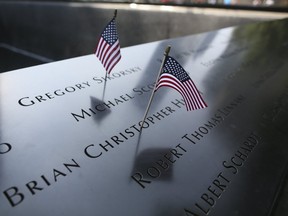 American flags are placed on the south pool of the National September 11 Memorial, Saturday, Sept. 10, 2016, in New York. Sunday marks the 15th anniversary of the attacks on the World Trade Center. (AP Photo/Mary Altaffer)