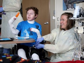 A photo of Jonathan Pitre has a popsicle while in hospital in Minneapolis earlier this week. He's undergone a high-stakes stem-cell transplant that doctors hope will improve the teen's quality of life.