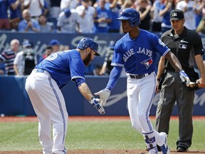 Russell Martin congratulates Melvin Upton Jr for his home run to make it 2-0 as Jays host Boston Red Sox in Toronto, Ont. on September 10, 2016. (Michael Peake/Toronto Sun/Postmedia Network)