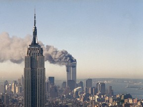 FILE - In this Sept. 11, 2001 file photo the twin towers of the World Trade Center burn behind the Empire State Building in New York after terrorists crashed two planes into the towers causing both to collapse. (AP Photo/Marty Lederhandler)