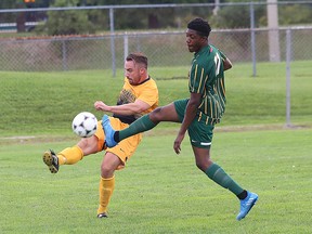 Marco Armiento, left, of Cambrian College, and Kayode Adebayo, of Fleming College, battle for the ball during soccer action at Cambrian College in Sudbury, Ont. on Saturday September 10, 2016. John Lappa/Sudbury Star/Postmedia Network
