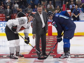 NHL hockey legend Patrick Roy, centre, drops the puck for a ceremonial face-off with Team Europe captain Anze Kopitar, right, and Team North America Connor McDavid at the beginning of a pre-tournament game at the World Cup of Hockey, Thursday, September 8, 2016 in Quebec City. (THE CANADIAN PRESS/Jacques Boissinot)