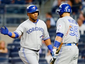 Edwin Encarnacion of the Toronto Blue Jays celebrates his first inning home run against the New York Yankees with teammate Russell Martin #55 at Yankee Stadium on September 6, 2016 in the Bronx borough of New York City. (Photo by Jim McIsaac/Getty Images)