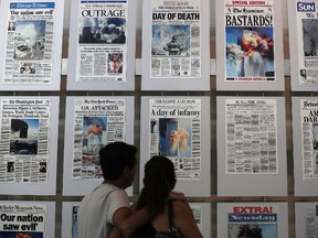 Visitors browse newspaper front pages with the story of the 9/11 terror attacks at the 9/11 Gallery of the Newseum on September 9, 2016 in Washington, DC. The nation will mark the 15th anniversary of the terror attacks on Sunday. (Photo by Alex Wong/Getty Images)