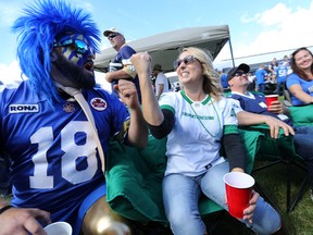 Saskatchewan Roughriders fan Christine Gray (right) and Winnipeg Blue Bomber fan Ryan Krause are at odds while tailgating prior to the Banjo Bowl in Winnipeg on Sat., Sept. 10, 2016. (Kevin King/Winnipeg Sun/Postmedia Network)