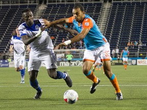 FC Edmonton defender Papé Diakité battles for the ball with Miami FC striker Pablo Campos earlier this season. Miami won the game 1-0. The two teams face each other again Sunday (2 p.m.) at Clakre Stadium.