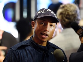 Pharrell Williams, producer of "Hidden Figures," is interviewed before a photo call for the film on day 3 of the Toronto International Film Festival at the TIFF Bell Lightbox on Saturday, Sept. 10, 2016, in Toronto. (Photo by Chris Pizzello/Invision/AP)