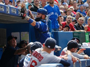 Toronto Blue Jays catcher Russell Martin goes into the visitors' dugout to try to catch a foul ball in a game against the Boston Red Sox on Sept. 10, 2016. (MICHAEL PEAKE/Toronto Sun)
