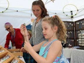 Eight-year-old Indie Bothwell checks out a piece of jewellery along with Cloe Gonyou from Bright's Grove during Art in the Park on Saturday, Sept. 10, 2016 in Bright's Grove, Ont. The annual event is run by the Rotary Club of Sarnia Bluewaterland. Terry Bridge/Sarnia Observer/Postmedia Network
