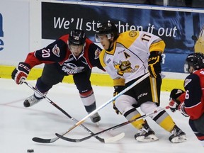 Sarnia Sting forward Travis Konecny pokes the puck away from Windsor Spitfires centre Andrew Burns during an Ontario Hockey League exhibition game at Progressive Auto Sales Arena on Saturday, Sept. 10, 2016 in Sarnia, Ont. Konecny scored a hat trick as the Sting rounded out the preseason with a 5-4 shootout win. Terry Bridge/Sarnia Observer/Postmedia Network