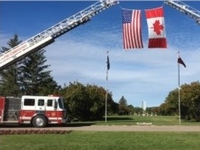 Fire trucks display the Canadian and American flags at the International Peace Gardens, where a memorial marked the 15th anniversary of the Sept. 11 attacks in the United States on Sunday, Sept. 11, 2016. (HANDOUT)
