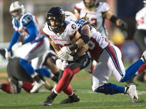 Ottawa Redblacks receiver Brad Sinopoli is tackled by Montreal Alouettes linebacker Bear Woods (48) in Montreal on Thursday, September 1, 2016. (THE CANADIAN PRESS/Paul Chiasson)