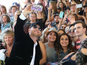 Tim Hicks takes a selfie with fans as country artists arrive on the green carpet for the Canadian Country Music Awards at Budweiser Gardens in London, Ont. on Sunday September 11, 2016. Craig Glover/The London Free Press/Postmedia Network