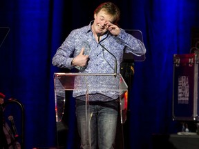 Ed "Pee Wee Charles" Ringwald wipes tears from his eyes as he accepts the award for Steel Guitar Player of the Year at the Canadian Country Music Association Gala at the London Convention Centre in London, Ont. on Saturday September 10, 2016. Craig Glover/The London Free Press/Postmedia Network