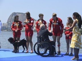 (L to R) Bronze medalists Victoria Nolan, Meghan Montgomery, Andrew Todd, Curtis Halladay and Kristen Kit from Canada receive medals from the President of the International Paralympic Committee Sir Philip Craven at the medal ceremony for the Rowing LTA Mix 4+ in Rio de Janeiro, Brazil. (Photo by Raphael Dias/Getty Images)