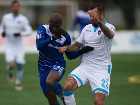 FC Edmonton's Sainey Nyassi battles a Miami FC player for the ball during Saturday's game at Clarke Stadium. (Greg Southam)