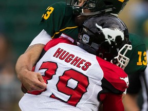 Eskimos quarterback Mike Reilly took a beating on this hit by Stampeders defensive lineman Charleston Hughes on Saturday at Commonwealth Stadium, much like his team is taking a beating in the standings. (Greg Southam)
